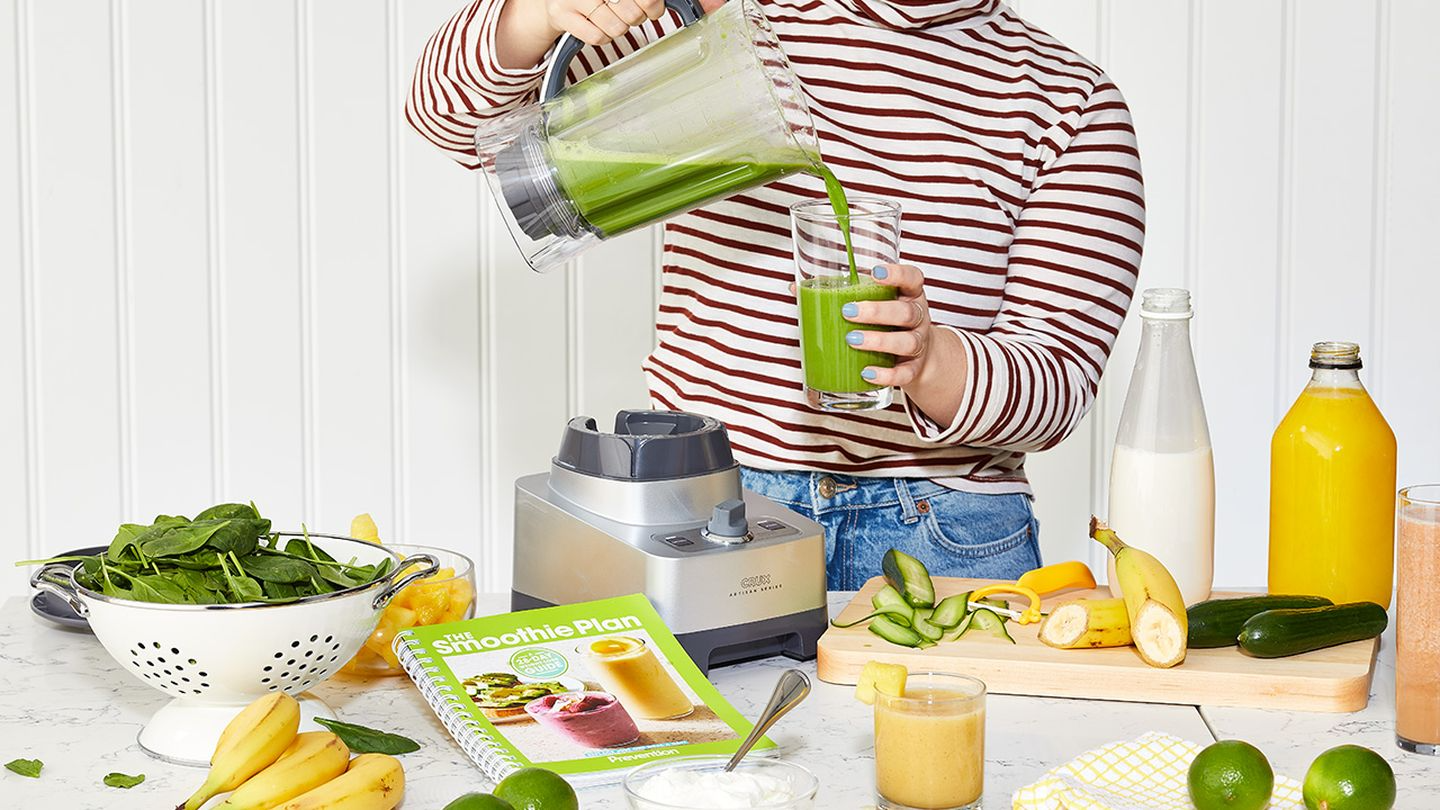 Woman pouring smoothie into a glass